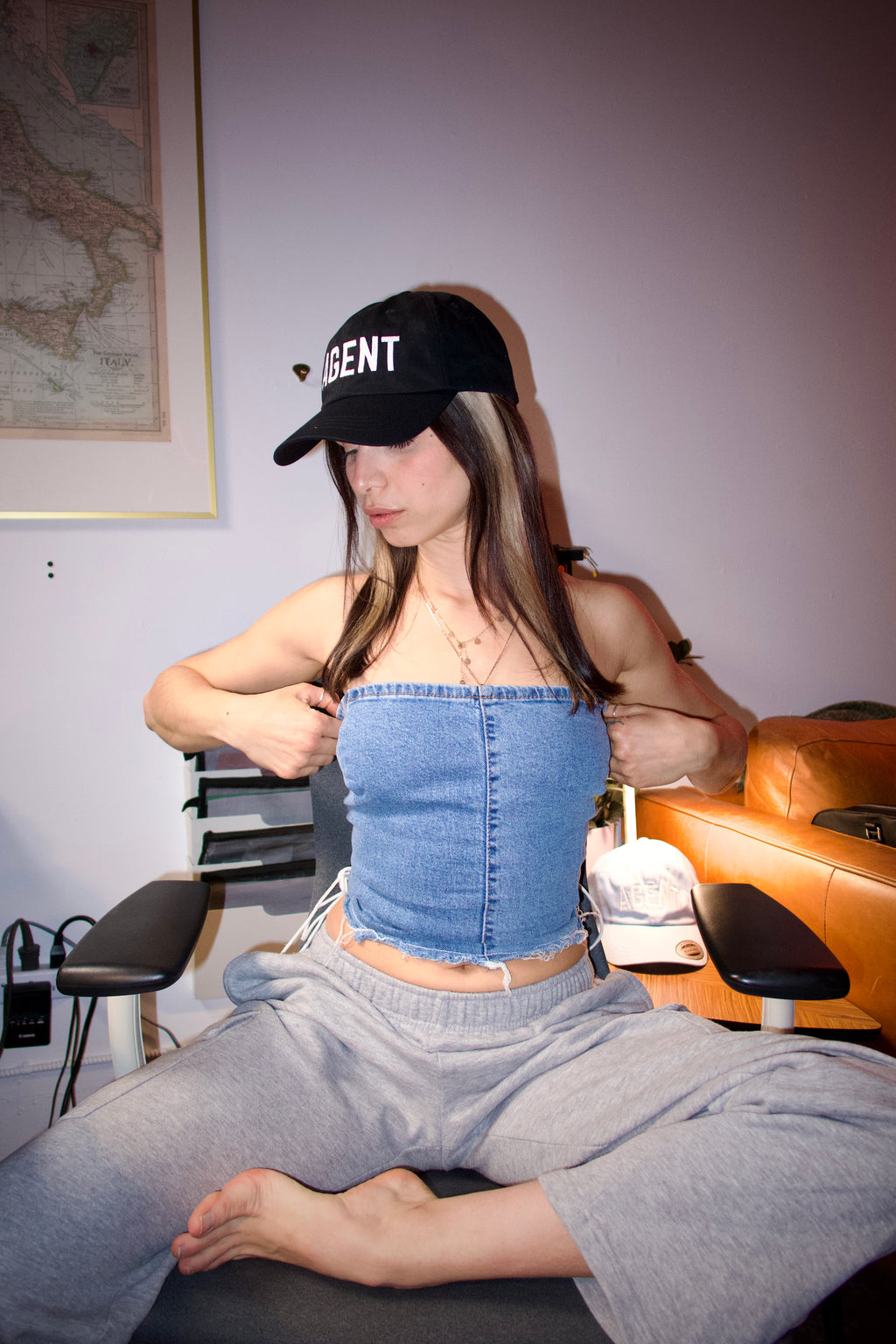 Agent black cap on girl in artist office flash photo sweatpants